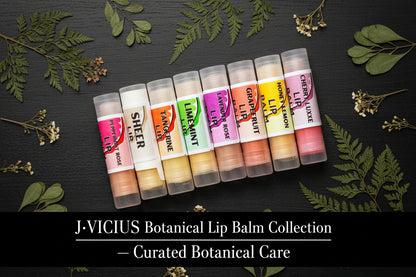 Set of lip balm tubes on a black wooden board with green leaves surrounding